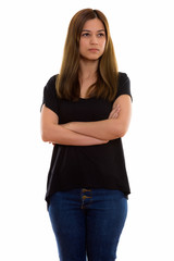 Studio shot of young beautiful woman standing and thinking with