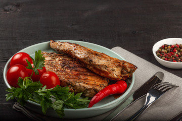 Tasty grilled chicken with fresh tomatoes on a dish