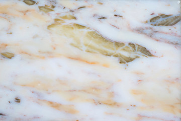 Beautiful background of blurry beige, white and yellow lines in the surface of natural marble tiles