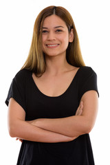 Fototapeta premium Studio shot of young happy woman smiling with arms crossed