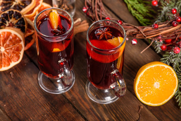 Christmas hot mulled wine with cinnamon cardamom and anise on wooden background