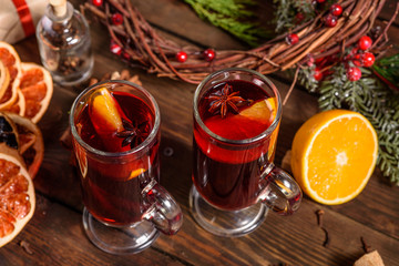 Christmas hot mulled wine with cinnamon cardamom and anise on wooden background