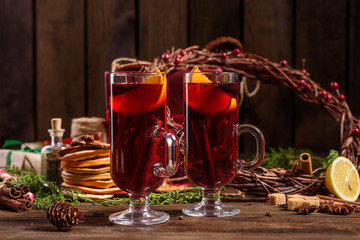 Christmas hot mulled wine with cinnamon cardamom and anise on wooden background