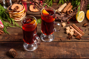Christmas hot mulled wine with cinnamon cardamom and anise on wooden background