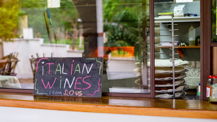 Italian wines chalkboard sign inside pizza restaurant