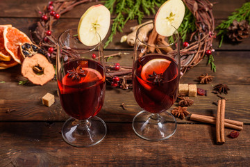 Christmas hot mulled wine with cinnamon cardamom and anise on wooden background