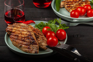 Tasty grilled chicken with fresh tomatoes on a dish