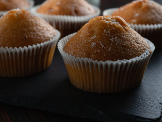 some juicy tasty muffins stuffed cupcakes. dark background