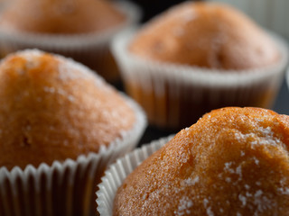 some juicy tasty muffins stuffed cupcakes. dark background