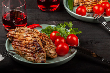 Tasty grilled chicken with fresh tomatoes on a dish