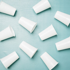Disposable plastic glasses on a blue background