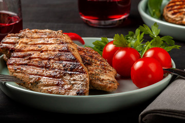 Tasty grilled chicken with fresh tomatoes on a dish