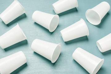 Disposable plastic glasses on a blue background