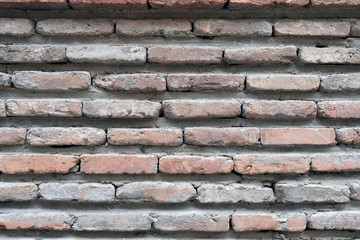 Old brick wall of brown color. Bricks pushed forward the background.