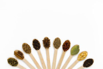 composition of assorted spices in wooden spoons on a white background. top view. flat lay. with copy spise