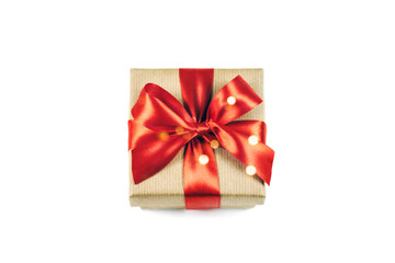 Festive gift box with red ribbon bow isolated on white.