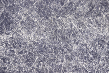 Fototapeta na wymiar Texture of a gray stone-washed denim fabric