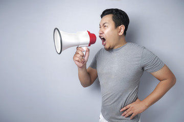 Young Man Shouting with Megaphone, Angry Expression