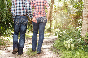 Young Couple In Love Walking Down Outdoors Nature Trail Path