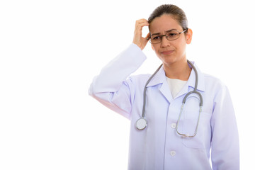 Fototapeta premium Studio shot of young stressed woman doctor thinking while scratc