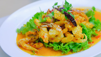 Close up Crispy Fish Maw in Spicy Salad with vegetable on white dish, thai food.