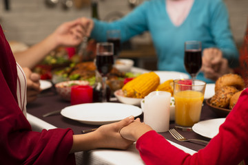 Obraz na płótnie Canvas Family holding hands on thanksgiving event