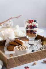 Trifle made with blueberries, red currants, whipped cream and star shaped pound cake in cozy autumn composition