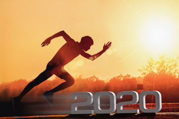Man fitness silhouette at sunrise, Jogging workout wellness, Happy New Year 2020 concept. - Image