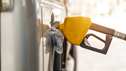fuel nozzle and car on gas station .Vehicle fueling facility at petrol station. Transportation and...