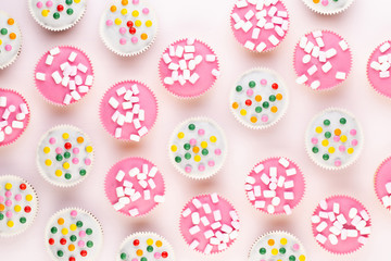Colorful cupcakes on a white background.