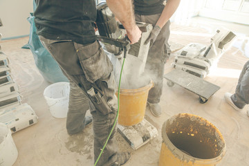 Mix the concrete solution in a bucket with a mixer