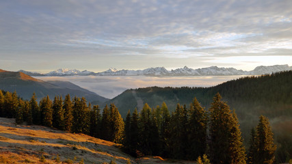 beautiful sunny morning on the mountains in autumn with view to the alps and a foggy valley