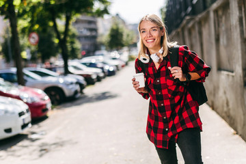 Fototapeta premium Young skater girl posing with coffee