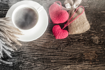 cup of coffee on a wooden plate with vintage color smoke.