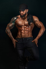 Fototapeta na wymiar Strong and fit man bodybuilder. Sporty muscular guy athlete. Sport and fitness concept. Men's fashion.