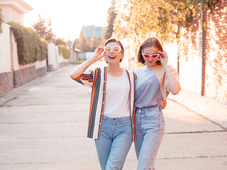 Two fashionable young women walking down the street