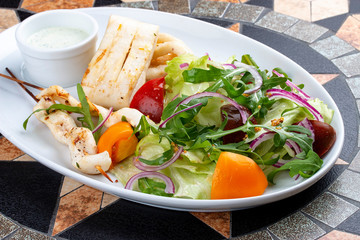 Squid fillet with vegetables in sauce