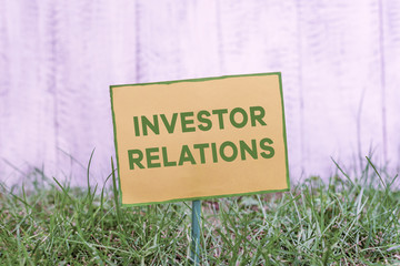 Handwriting text writing Investor Relations. Conceptual photo analysisagement responsibility that integrates finance Plain empty paper attached to a stick and placed in the green grassy land