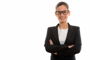 Studio shot of young happy businesswoman smiling while wearing e