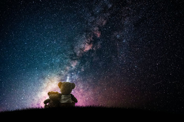 Couple love teddy bear (non branded) hugging on starry night sky, love concept	