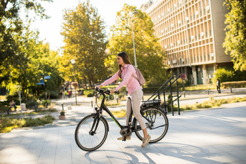 Young woman riding an electric bicycle