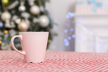 Merry Christmas. Decorated room no people cup of milk and cookies on table close-up