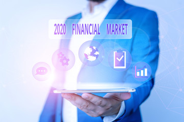 Conceptual hand writing showing 2020 Financial Market. Concept meaning place where trading of equities, bonds, currencies Male human wear formal suit presenting using smart device