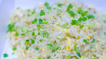 Close up Crab meat fried rice with Sliced chop ​​spring onion on white plate , Thai food.