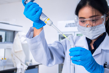 Interior of clean modern white medical or chemistry laboratory background. Scientist working at a...