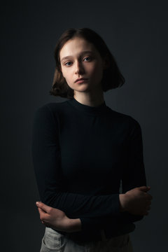 Portrait of young woman in shadows. 