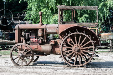 Fototapeta na wymiar Close up view of an old, rusty, abandoned tractor.