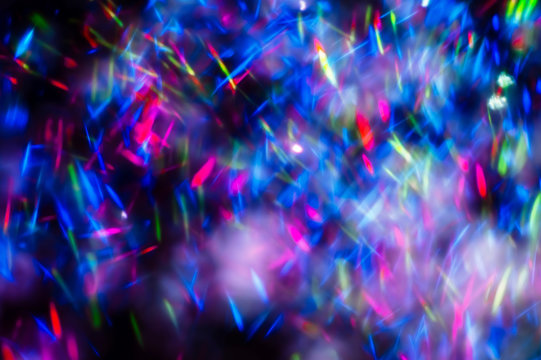Colorful lights blurred glitter background. Abstract illuminated texture. Christmas, new year or birthday celebration. Night life photography