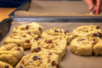 On a baking sheet is not ready-baked Stollen confectionery. Concept: Christmas and baking