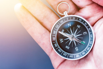 Innovation concept: Man is holding a compass in his hand, closeup cutout © Patrick Daxenbichler
